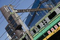 Japan, Tokyo, Shinbashi, a JR Yamanote line train crosses overhead.