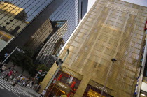 Japan, Tokyo, Ginza, Golden facade of the Cartier Building with the Chanel Building on left and DeBeers curved facade reflected in black glass on Chuo-dori Avenue.