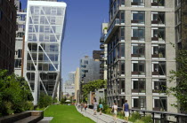 USA, New York, Manhattan, West Side, Highline Park at 23th St, the HL23 Building on the left, projecting over the park with people strolling.