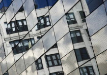 USA, New York, Manhattan, West Side, High Line Park north of 23th St, new building with old building reflected in windows.