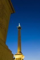 England, London, Nelsons Column illuminated at Dusk.