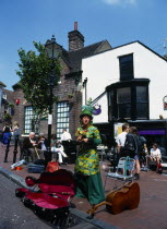England, East Sussex, Brighton, The Lanes, Busker in Market Square during the annual May arts festival.