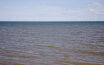 England, Lincolnshire, Skegness, Lincs Wind Farm offshore on the horizon showing turbine blades.