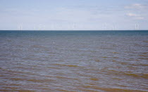 England, Lincolnshire, Skegness, Lincs Wind Farm offshore on the horizon showing turbine blades.