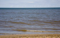 England, Lincolnshire, Skegness, Lincs Wind Farm offshore on the horizon showing turbine blades.