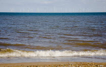 England, Lincolnshire, Skegness, Lincs Wind Farm offshore on the horizon showing turbine blades.