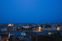 Hungary, Budapest, Buda Castle District, view over Danube and Pest with St Stephen's Basilica illuminated.