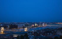 Hungary, Budapest, Buda Castle District, view over Danube and Pest with Memorial Chain Bridge illuminated.