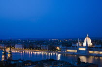 Hungary, Budapest, Buda Castle District: view over Danube and Pest with Parliament Building illuminated.
