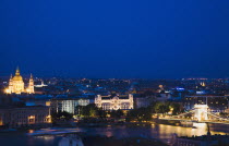 Hungary, Budapest, Buda Castle District, view over Danube and Pest with St Stephen's Basilica illuminated.