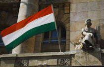 Hungary, Budapest, Hungarian Flag flying with Art Nouveau facade behind in central Pest.