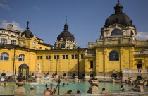 Hungary, Budapest, Pest, Outdoor bathing in summer at Szechenyi thermal baths, largest in Europe.