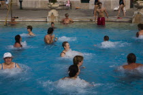 Hungary, Budapest, Pest, Mixed group outdoor bathing in summer at Szechenyi thermal baths, largest in Europe.
