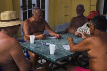 Hungary, Budapest, Pest, Male bathers playing cards in summer at Szechenyi thermal baths, largest in Europe.