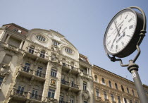 Hungary, Budapest, Clock with Art Nouveau facade behind  in central Pest.