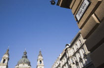 Hungary, Budapest, St Stephen's Basilica with Street sign and facades in central Pest.