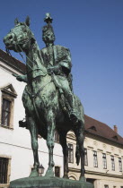 Hungary, Budapest, Buda Castle District: Bronze statue of mounted Hussar on street of restored facades.