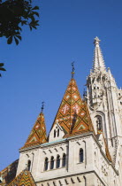 Hungary, Budapest, Buda Castle District, the tiled Bela tower with Matyas Church behind.