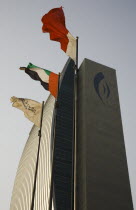 UAE , Dubai, National Bank of Dubai building with flags overlooking the Creek.