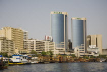 UAE , Dubai, Creek with Twin Towers shopping mall and skyline behind.