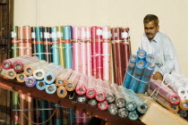 UAE , Dubai, Expat from subcontinent loading colourful textiles at Souk on Bur Dubai side of the Creek.