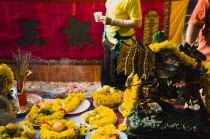 Thailand, Bangkok, Offerings on table with embroidered panel behind carried in parade celebrating local temple.
