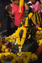 Thailand, Bangkok, Women in pink to honour the King with Offerings on table for parade celebrating local temple.