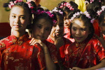 Thailand, Bangkok, High School girls in Chinese Cheong sam dress in parade celebrating local temple.