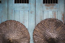 Thailand, Bangkok, Vintage conical straw hats displayed on wall.