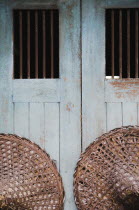 Thailand, Bangkok, Vintage conical straw hats displayed on wall.