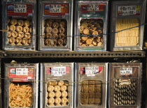 Thailand, Bangkok, Biscuits on sale loose by weight from display tins on New Road the first surfaced road in the city.