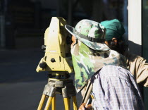 Thailand, Bangkok, Chinatown, Surveyor in camouflage shade in hot afternoon sun.