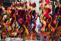 Thailand, Bangkok, Children's toy dragons on stall in Chinatown for Chinese New Year.