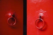 Thailand, Bangkok, Temple doors painted bright red an auspicious colour.