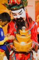 Thailand, Bangkok, Imperial Chinese performer colecting donations for Chinese New Year.