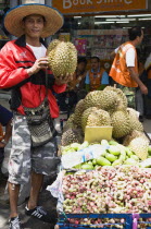 Thailand, Bangkok, Thai man selling Durian fruit from cart.