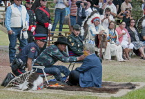 Canada, Alberta, Stand Off, Canada's Prime Minister, Stephen Harper, seated on a buffalo skin rug as Medicine Man Pete Standing Alone applies paint to his face as part of the ceremony to induct him in...