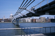 England, London, View along the Millennium footbridge over the river Thames toward St Pauls Cathedral and city.