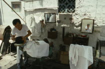 Malaysia, Penang, Georgetown, man having a shave from a street barber.