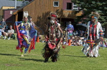 Canada, Alberta, Waterton Lakes National Park, Pow Wow at the Blackfoot Arts & Heritage Festival to celebrate Parks Canada's centennial, Head dancers Jenny Yellow Horn and Aryson Black Plume centre in...