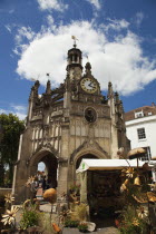 England, West Sussex, Chichester, The Market Cross and a wooden craft market store in the foreground.