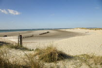 England, West Sussex, West Wittering Beach, View across sand dunes towards beach and sea at East Head. Sunshine and blue sky.