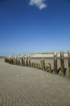 England; West Sussex; Chichester; West Witterings; East Head, Wooden Groynes and sandy beach at low tide.