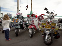 England, East Sussex, Brighton, Elaborately decorated Mopeds on Madeira Drive during motorbike festival.