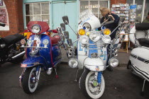 England, East Sussex, Brighton, Elaborately decorated Mopeds on Madeira Drive during motorbike festival.