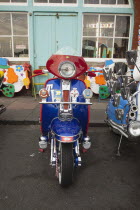 England, East Sussex, Brighton, Elaborately decorated Mopeds on Madeira Drive during motorbike festival.