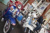 England, East Sussex, Brighton, Elaborately decorated Mopeds on Madeira Drive during motorbike festival.