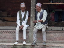 Nepal, Kathmandu, Two older men in national clothes are talking.