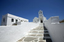 Greece, Cyclades Island, Sifnos Island, Landscape format low angle photograph of the church inside Chrissopigi monastery which is build on the top of a cliff nearby Platis Yalos village and it is famo...