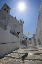 Greece, Cyclades, Islands, Sifnos Island, Apollonia Town, Portrait format low angle photograph of a typical alley found only at Cyclades island complex with the church of Agios Spyridonas on the left...